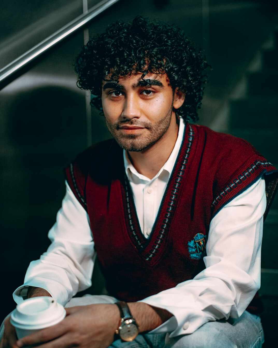 Portrait of a young man with curly hair and sweater