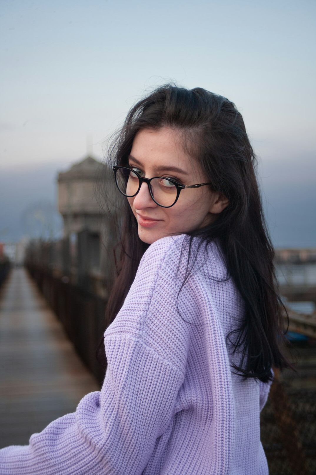 Portrait of a woman with glasses and purple cardigan