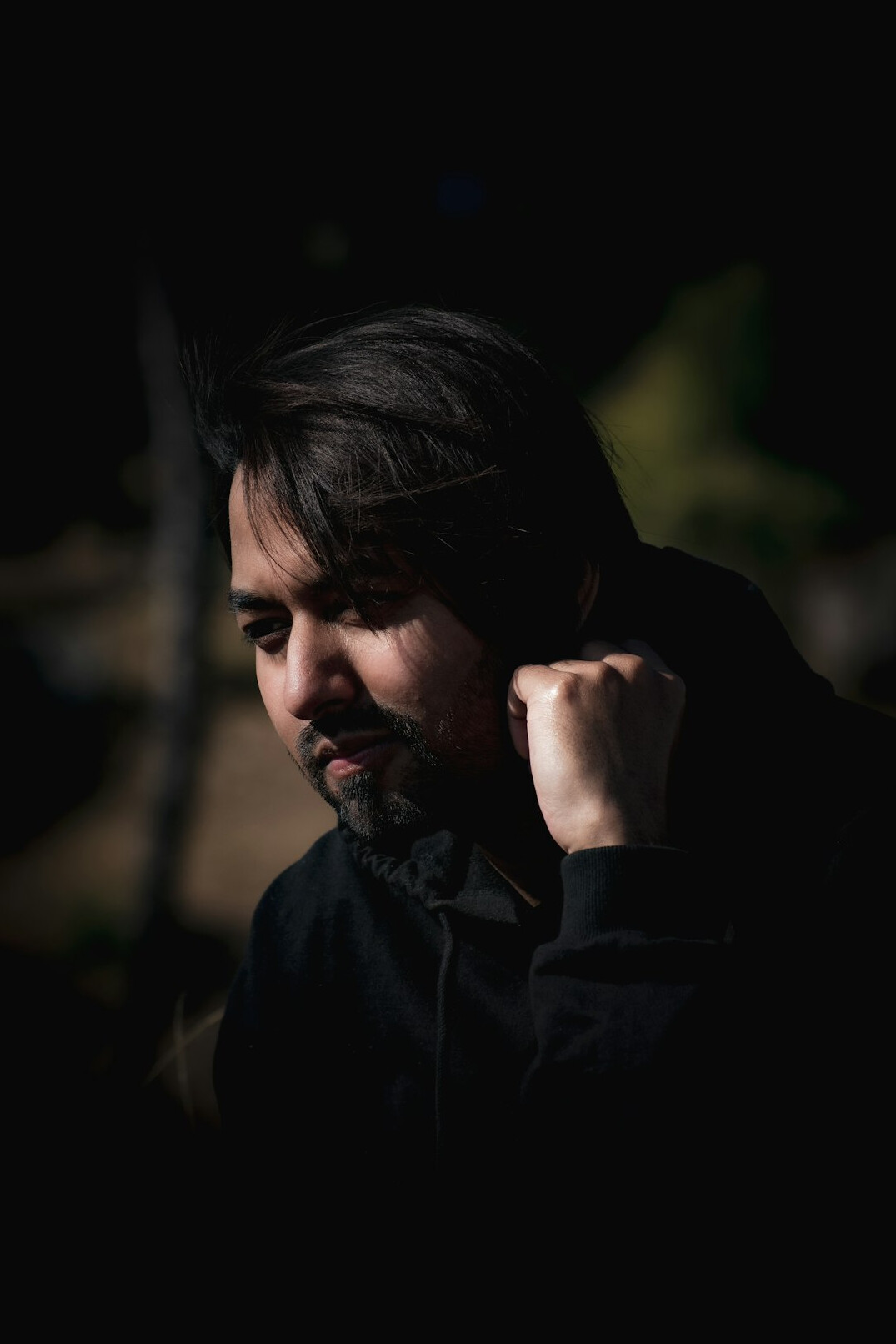 Portrait of a man with a beard in dark clothing