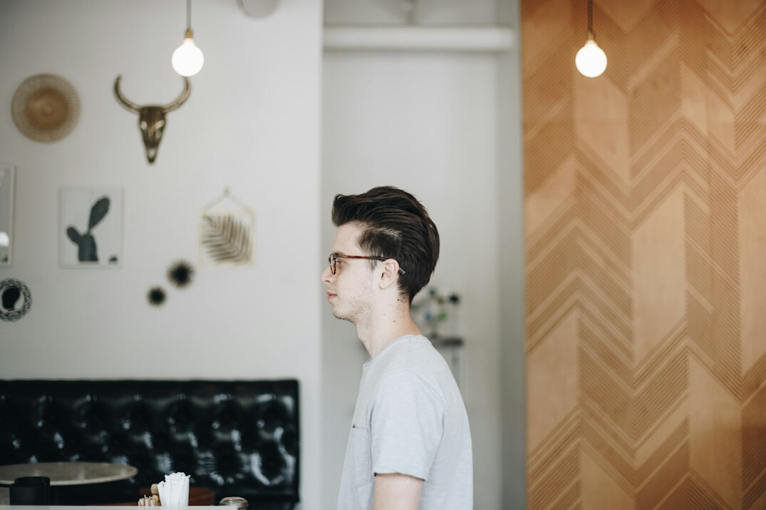 Smiling young man with glasses indoors