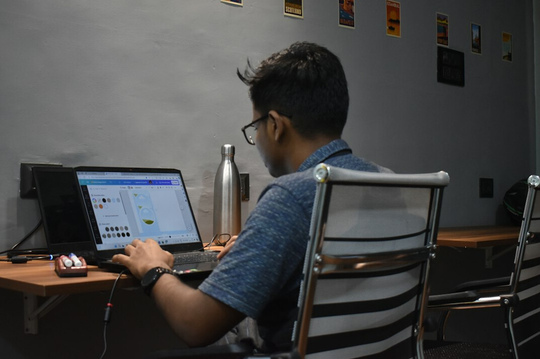 student learning programming on laptop