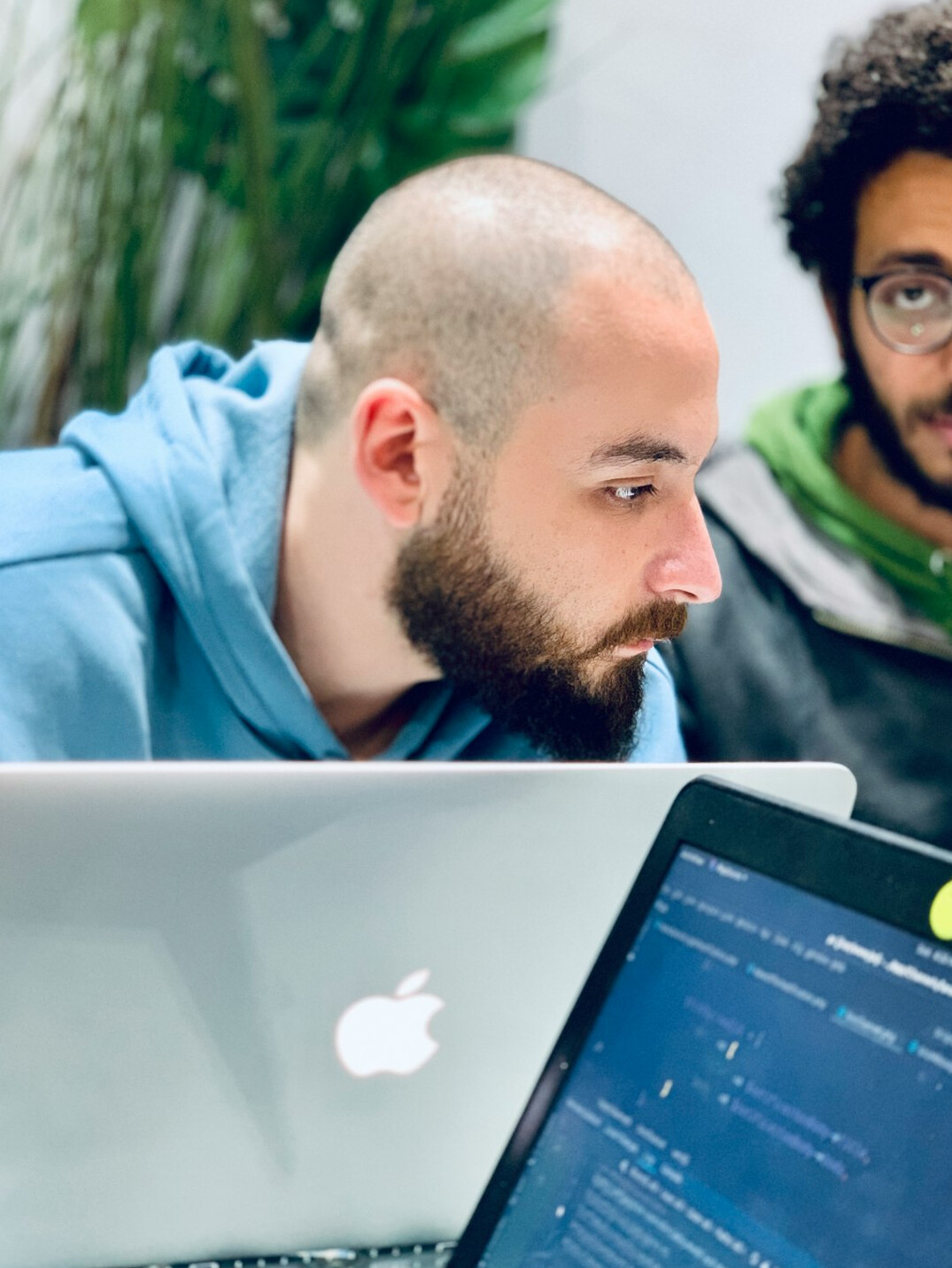 students coding on laptops